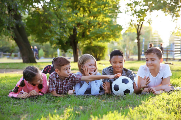 Cute kids with sport ball on green grass - Фото, изображение