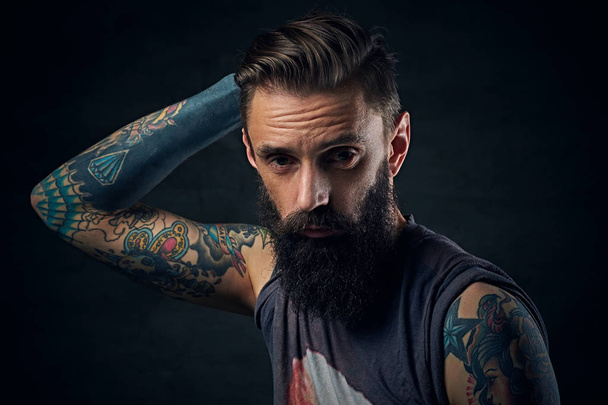 Bearded man in a t shirt touches his head - Photo, Image