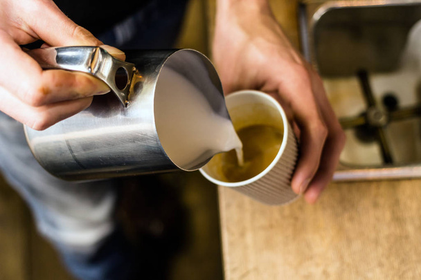 Barista pouring milk to takeaway coffee. - Fotografie, Obrázek