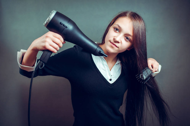 Portrait of beautiful woman, she holding hair dryer - Photo, Image