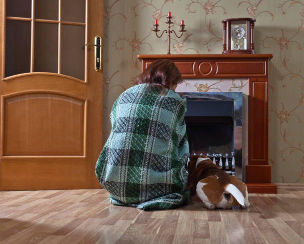 woman with  beagle near a fireplace - Photo, Image