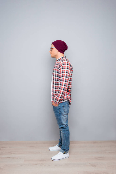 Full side view portrait of young hipster guy holding hands in po - Photo, Image