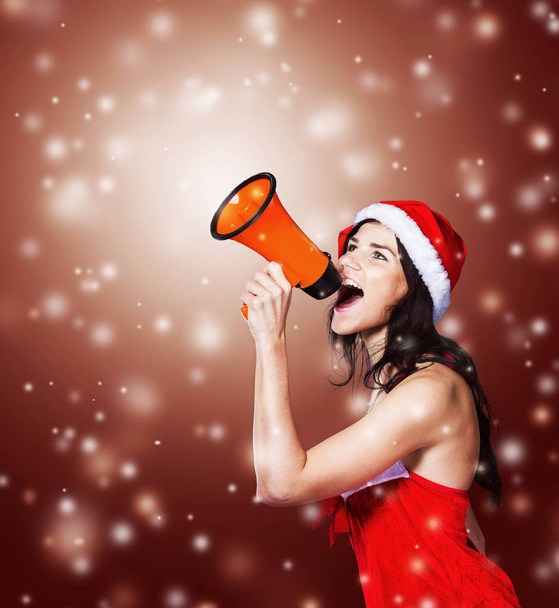 beautiful girl in costume of Santa Claus with a megaphone  - Fotoğraf, Görsel