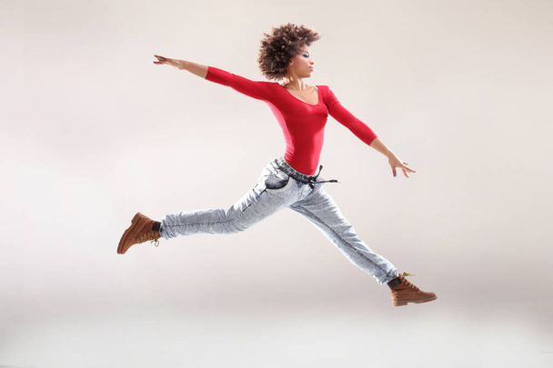 Young girl with afro dancing. - Фото, зображення