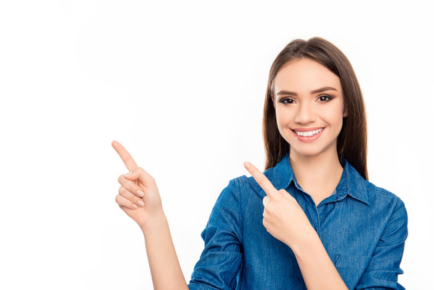 Happy young cheerful woman showing way with fingers - Фото, изображение