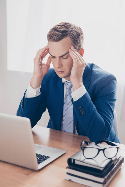 Overworked businessman having headache and thinking how to end p - Photo, image