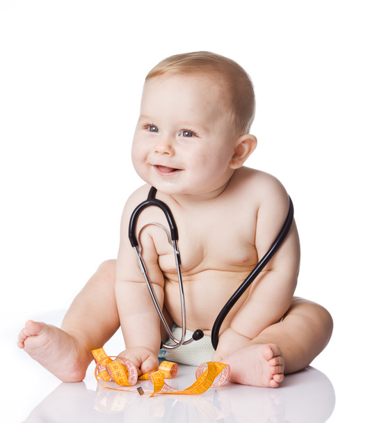 Sweet baby with stethoscope and measure tape on a white backgrou - Фото, изображение