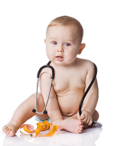 Sweet baby with stethoscope and measure tape on a white backgrou - Photo, Image