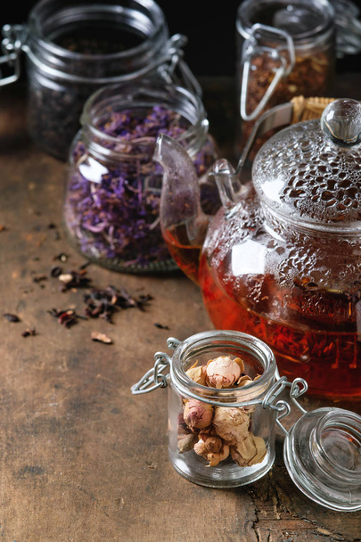 Variety of dry tea with teapot - Фото, зображення
