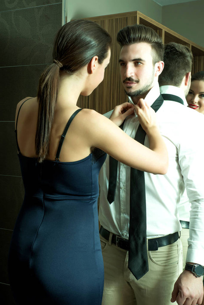 A young couple getting dressed in the changing room - Fotografie, Obrázek
