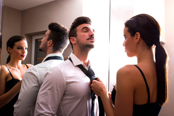 A young couple getting dressed in the changing room - Foto, imagen