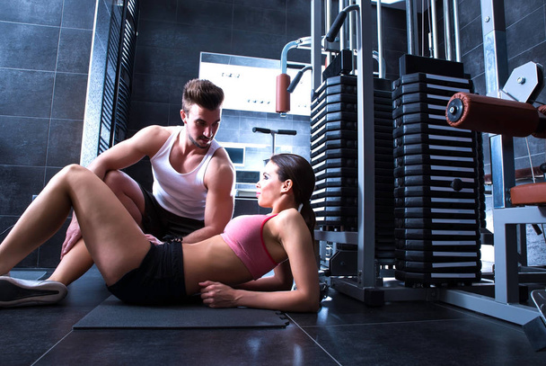 Young woman with her personal trainer in the Gym - Foto, Imagem