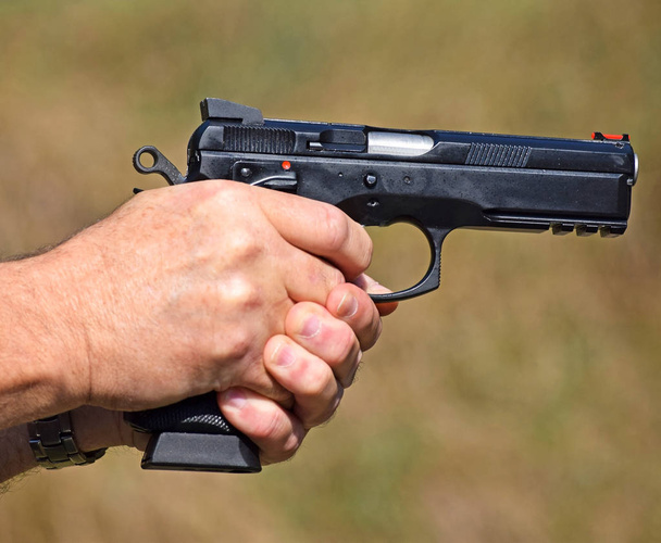 Shooting with a handgun outdoor - Foto, Imagen