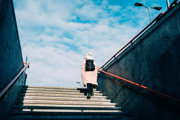 woman going upstairs  - Фото, изображение