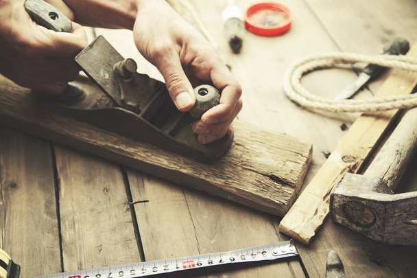 carpenter working on wooden background - Фото, изображение