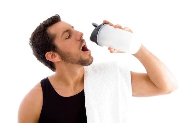 Man drinking while exercising - Фото, изображение