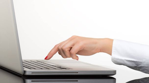 Closeup of business woman hand typing on laptop keyboard - 写真・画像
