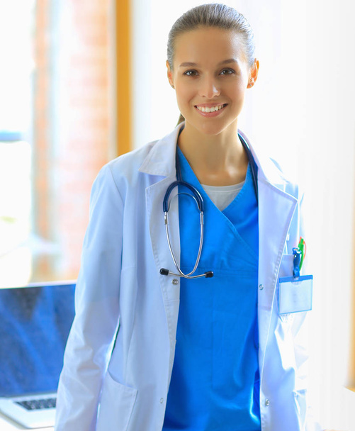 Woman doctor standing at hospital - Фото, изображение