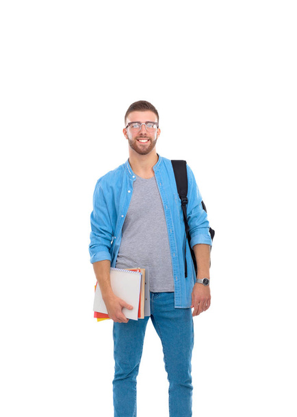 Male student with a school bag holding books isolated on white background - Фото, зображення