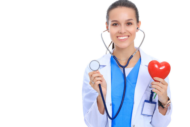 Doctor with stethoscope examining red heart, isolated on white background - Fotó, kép