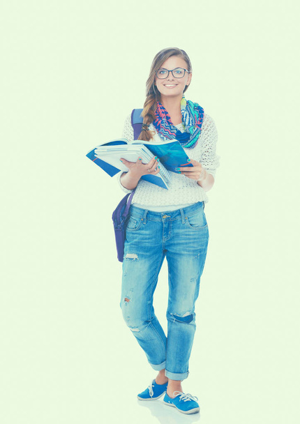 Portrait of a young student woman holding exercise books. - Photo, image