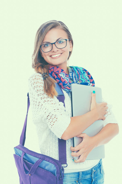 Smiling teenager with laptop on white background - Foto, imagen