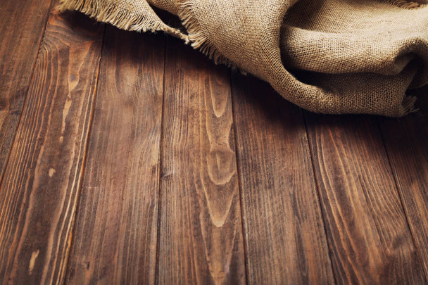 Sackcloth on wooden table - Фото, изображение