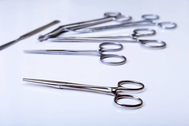 surgical instruments and tools including scalpels, forceps tweezers arranged on a table for surgery - Foto, Imagen