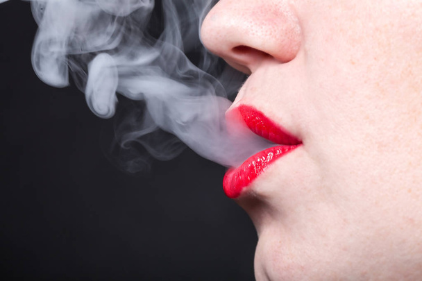 Profile view of a woman with vapor  - Photo, image