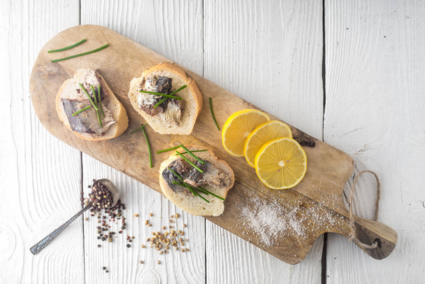 Sandwiches with sardines on a cutting board - Photo, Image