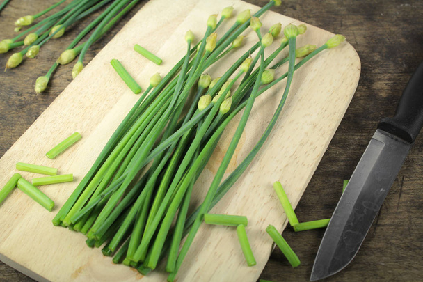 bunch of fresh chives on a wooden cutting board - Photo, Image