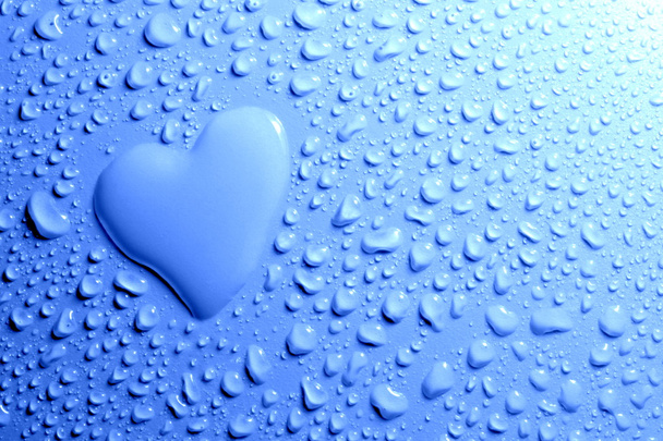 Water drops and heart shape on blue background - Foto, imagen