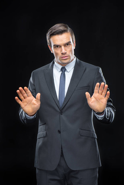 Handsome businessman gesturing - Фото, изображение