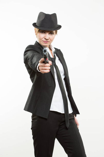 girl gangster holding a gun. Classic suit and hat. - Foto, immagini
