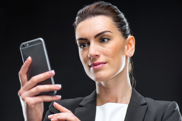 Businesswoman using smartphone - Фото, зображення