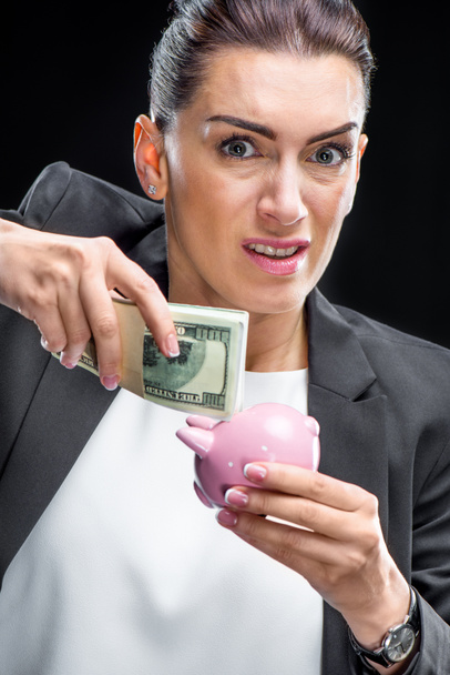 Businesswoman holding piggybank - Zdjęcie, obraz