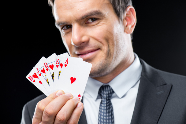 Man holding playing cards  - Foto, afbeelding
