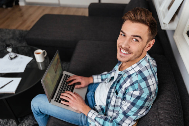 Smiling bristle man using laptop computer. - Photo, Image