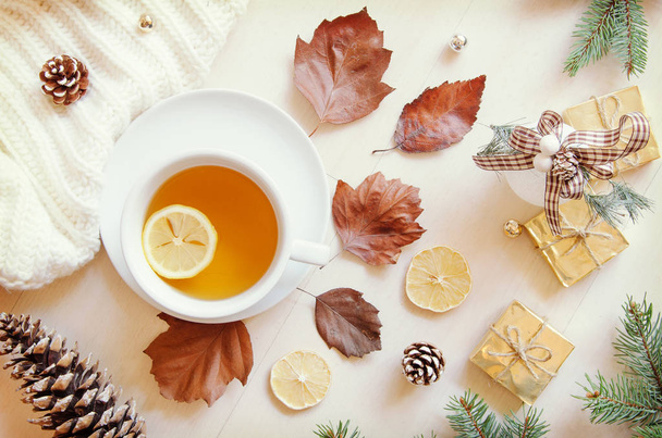 Composition with tea, leaves, cone,lemon and knitted sweater. Top view, flat lay - Photo, image
