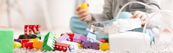 Kid with toys and asthma inhaler - Zdjęcie, obraz