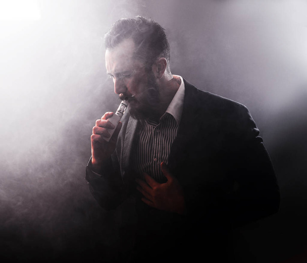 Man coughing a lot after using vaponizer electronic cigarette - Photo, Image