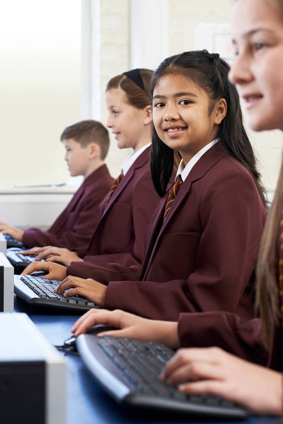 Pupils Wearing School Uniform In Computer Class  - 写真・画像