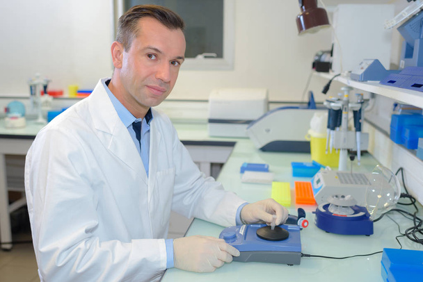 happy young male researcher working in his lab - Foto, afbeelding