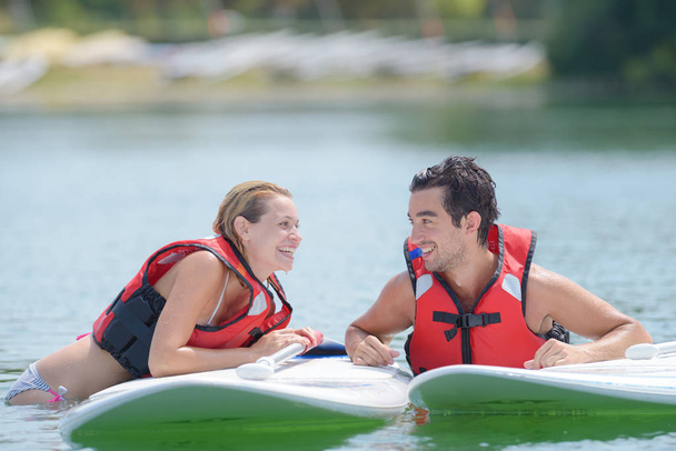 happy couple and their paddle boards - Photo, Image