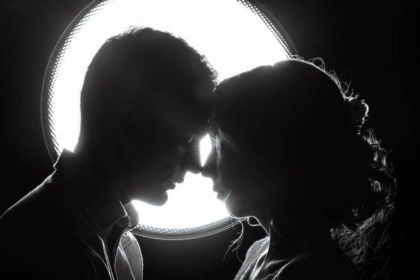 silhouette of a loving couple in the rays of light - Photo, Image