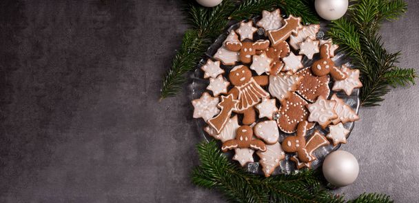 baked Gingerbreads with icing on plate for christmas - Фото, изображение