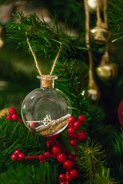 Fragment of the Christmas tree decorated with letter and key in the bottle. - Foto, Imagem