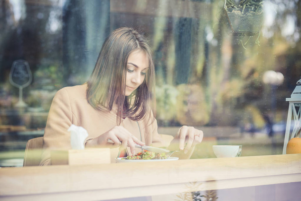 healthy eating, dieting and people concept - close up of young woman eating vegetable salad in coffee shop - Valokuva, kuva