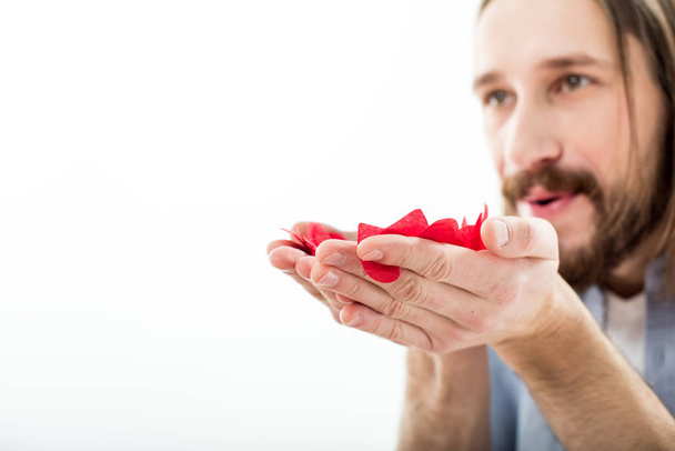 Man blowing paper hearts  - Фото, зображення