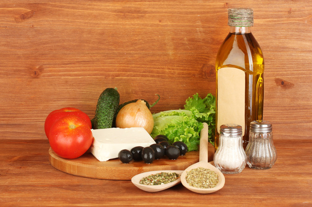 Ingredients for a Greek salad on wooden background close-up - Foto, Imagen